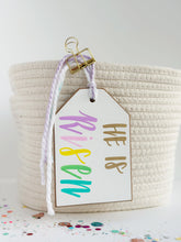 Load image into Gallery viewer, HE IS Risen Tag (multicolor lettering)
